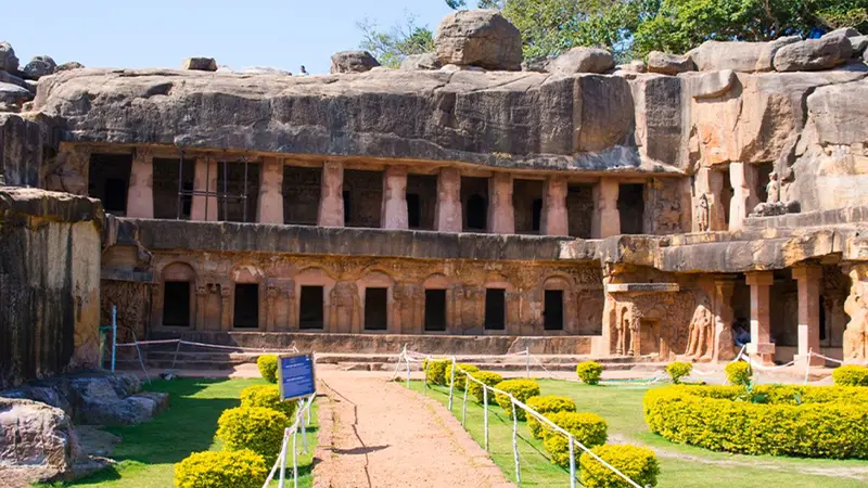 Historic cave monastery courtyard surrounded by rock-cut chambers