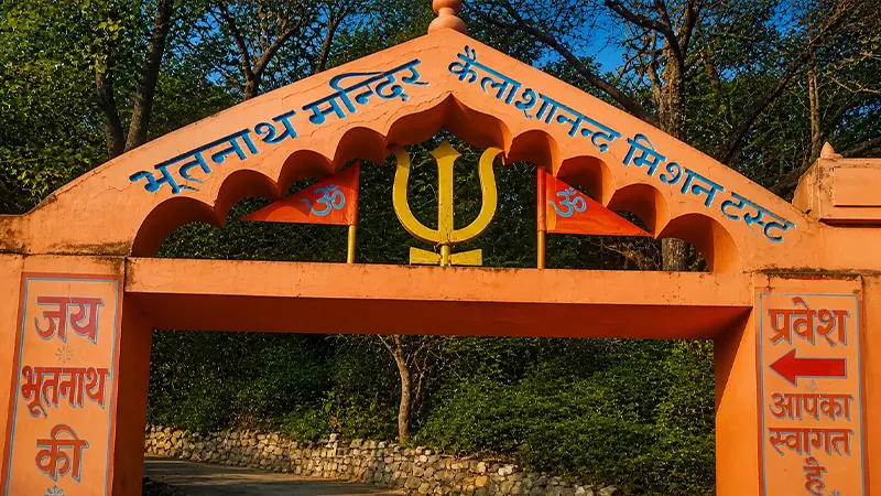 Entrance gateway leading to an ancient cave shrine surrounded by forests