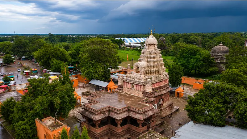 Ancient stone sanctuary surrounded by greenery showcasing rich cultural and spiritual heritage