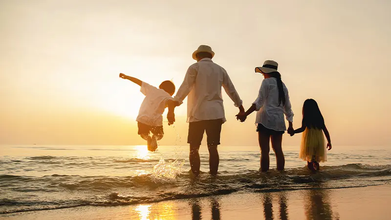 Family enjoying a sunset beach holiday in Bali