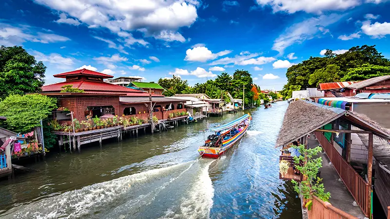 Traditional long-tail boat cruising through Bangkok canals