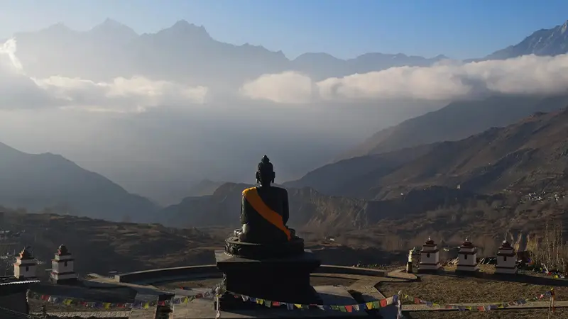 Large Buddha statue overlooking mountain valleys in Nepal