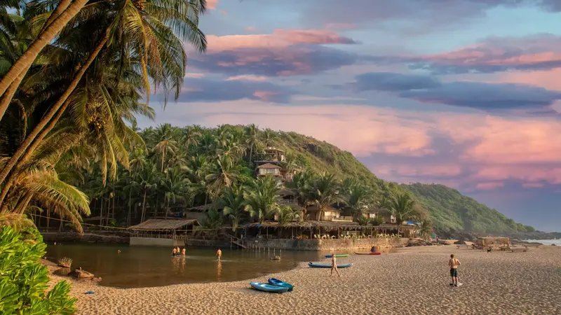 Cola Beach lagoon with golden sand and coconut palms in South Goa