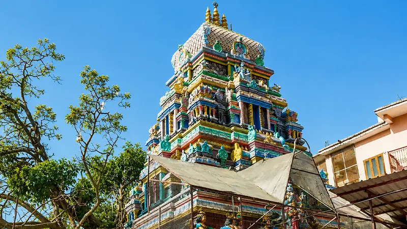 Intricately carved Dravidian temple tower with vibrant sculptures