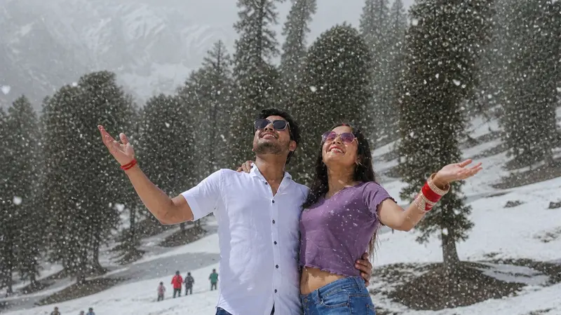 Couple Enjoying Fresh Snowfall Hills