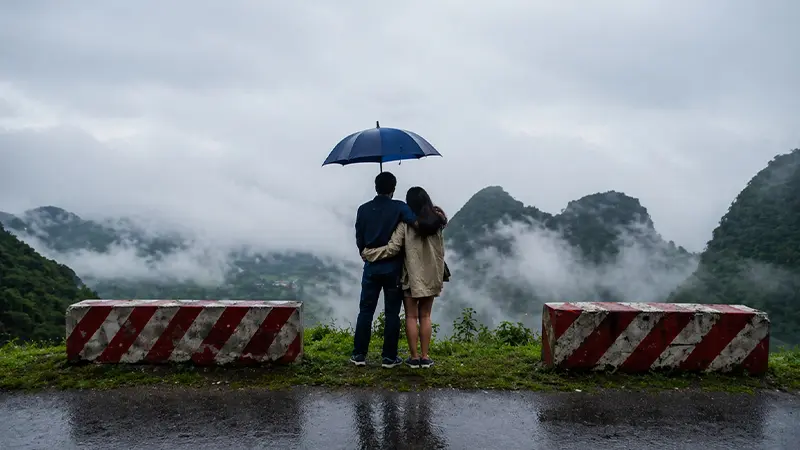 Couple enjoying a romantic misty mountain viewpoint during the Darjeeling honeymoon tour