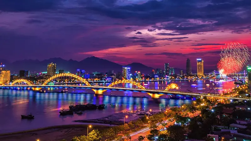 Illuminated river bridge and city lights creating a vibrant night view