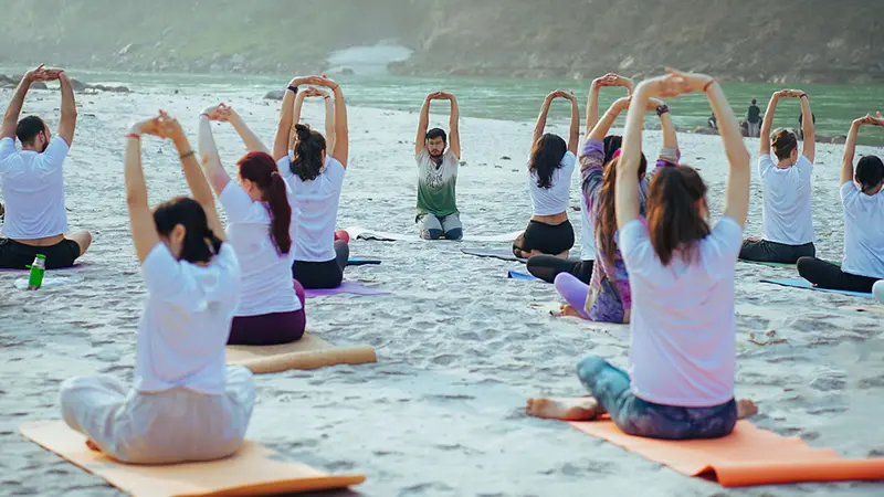 Yoga session on Ganga riverbank in Rishikesh