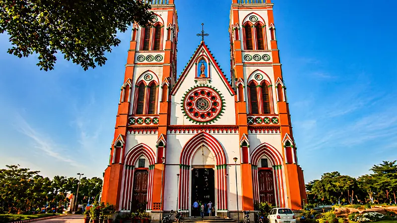 Historic cathedral facade featuring twin towers and stained windows
