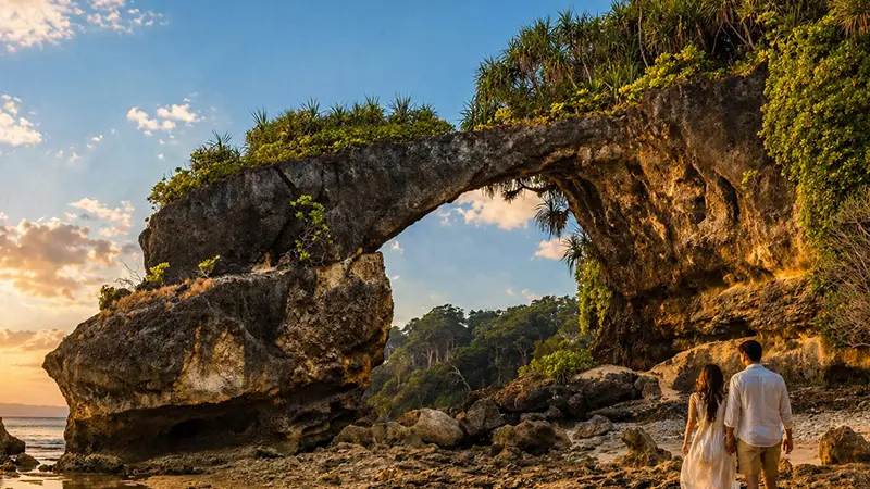 Natural rock bridge on the Andaman coast at sunset