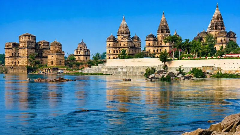 Historic palace and temple structures lining a scenic riverbank
