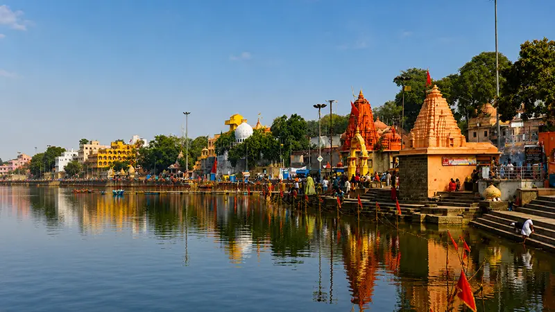 Ancient lakeside pilgrimage corridor lined with shrines and temple structures