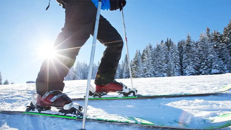 Winter sports enthusiast skiing across snow-covered alpine terrain