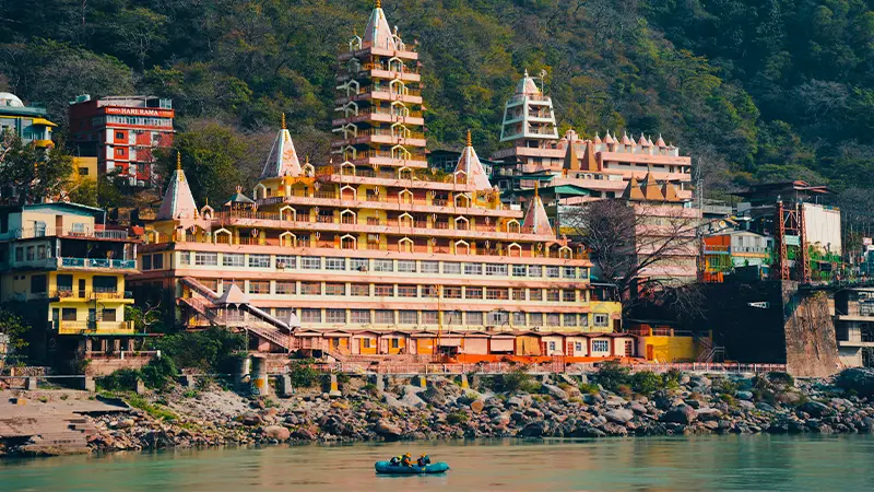 Large spiritual retreat complex overlooking a serene river landscape