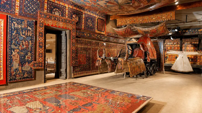 Traditional Gujarat textile museum displaying handcrafted carpets, fabrics, and royal heritage artifacts