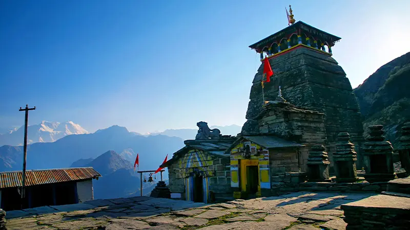 Ancient Tungnath temple shrine set against Himalayan mountain views