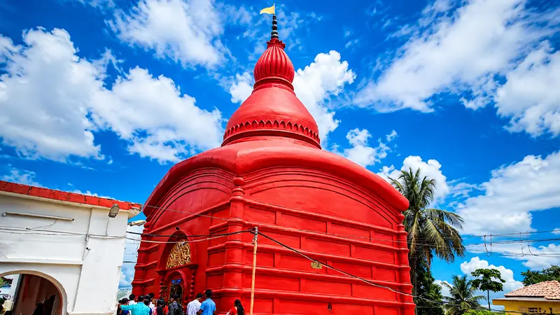 Vermilion-colored Shakti shrine revered by devotees on a Tripura pilgrimage