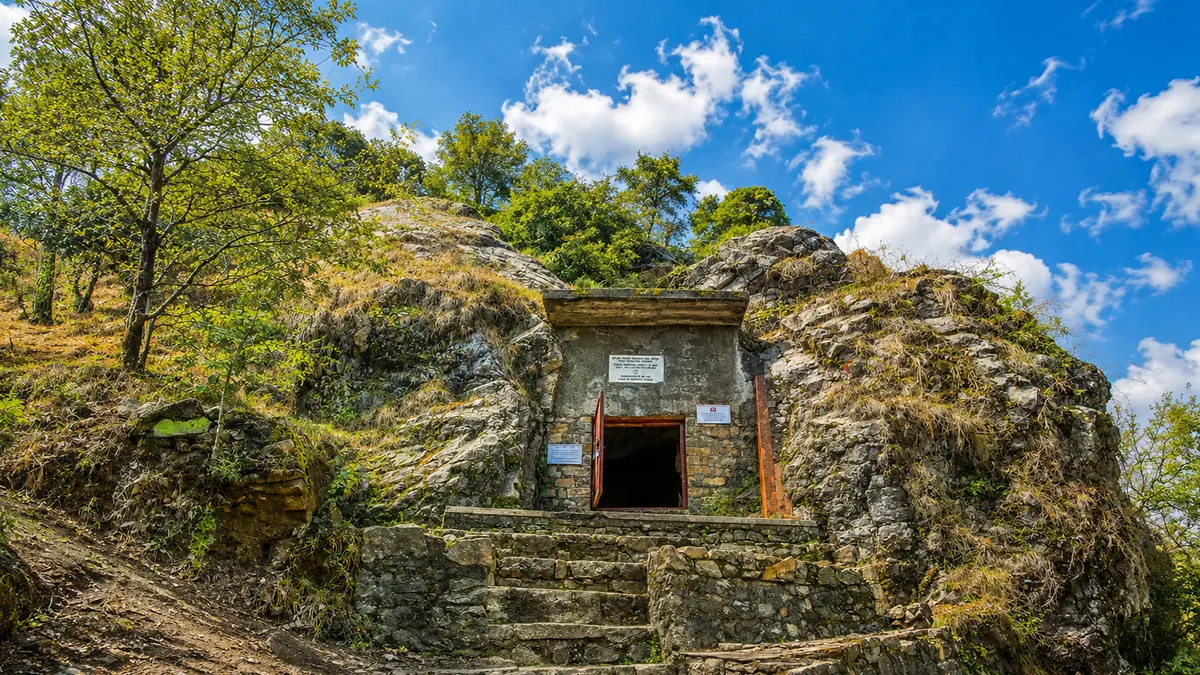 Historic meditation cave carved into rocky Himalayan terrain
