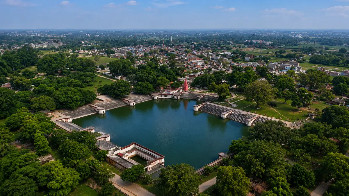 Historic ritual water tank surrounded by greenery and pilgrimage pathways