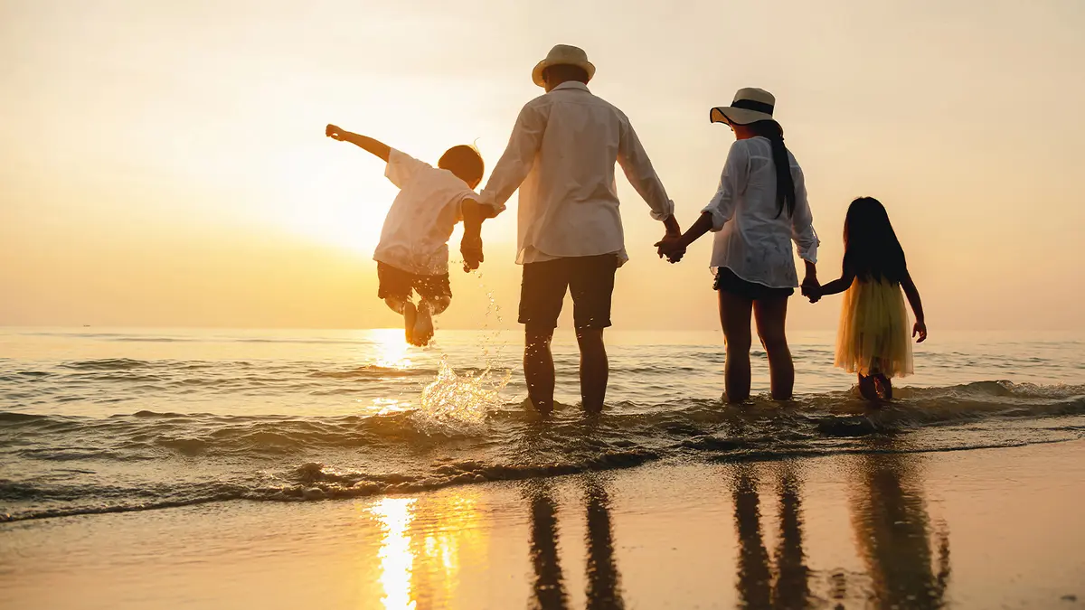 Family enjoying a sunset beach holiday in Bali