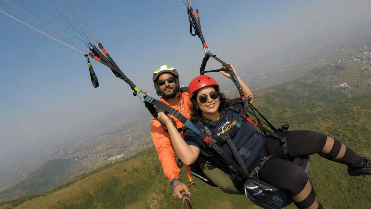 Couple enjoying tandem paragliding over Bir Billing near Dharamshala
