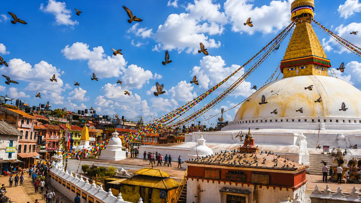 Boudhanath Stupa with prayer flags and pigeons in Kathmandu