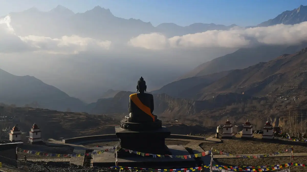 Large Buddha statue overlooking mountain valleys in Nepal