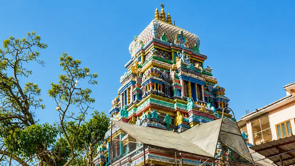 Intricately carved Dravidian temple tower with vibrant sculptures