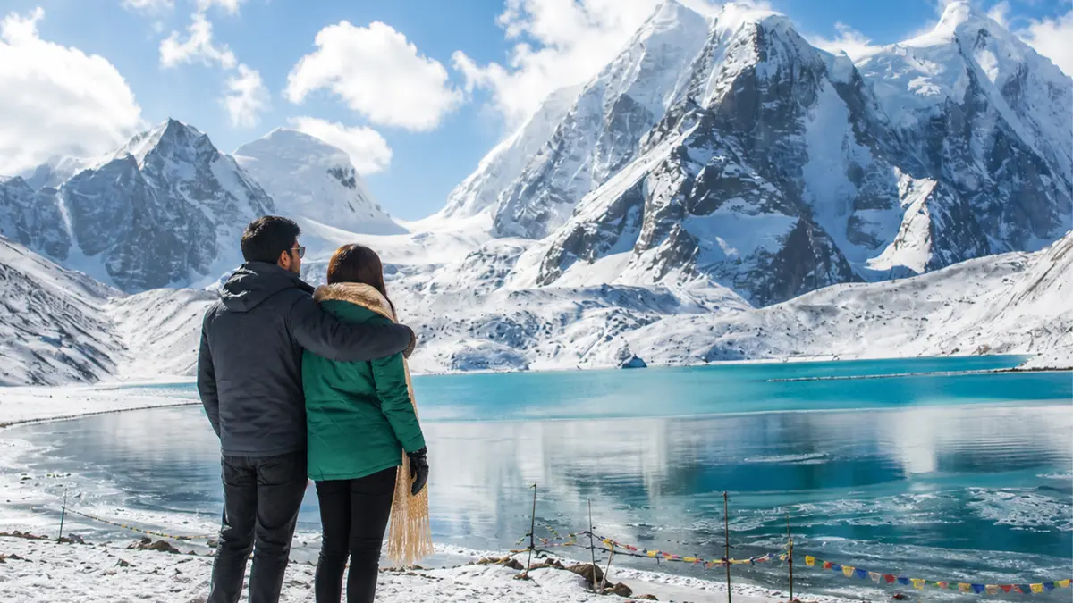 Couple enjoying panoramic views of Tsomgo Lake during a romantic Sikkim holiday