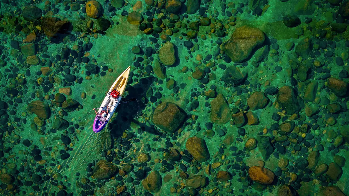 Kayak floating on the crystal clear waters of Dawki River Meghalaya