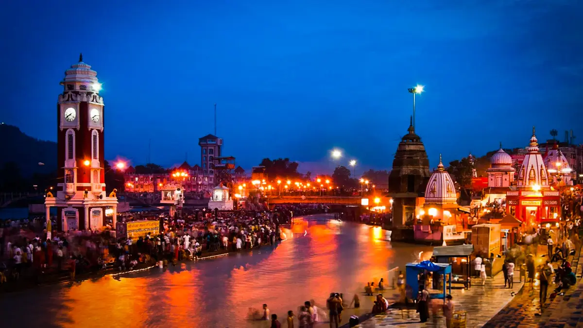 Devotees gathered along a riverside promenade during evening prayers