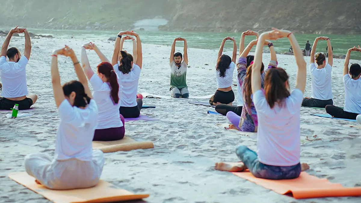 Yoga session on Ganga riverbank in Rishikesh