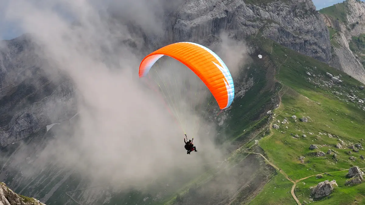 Colorful paraglider soaring above the mountains at Bir Billing Himachal Pradesh