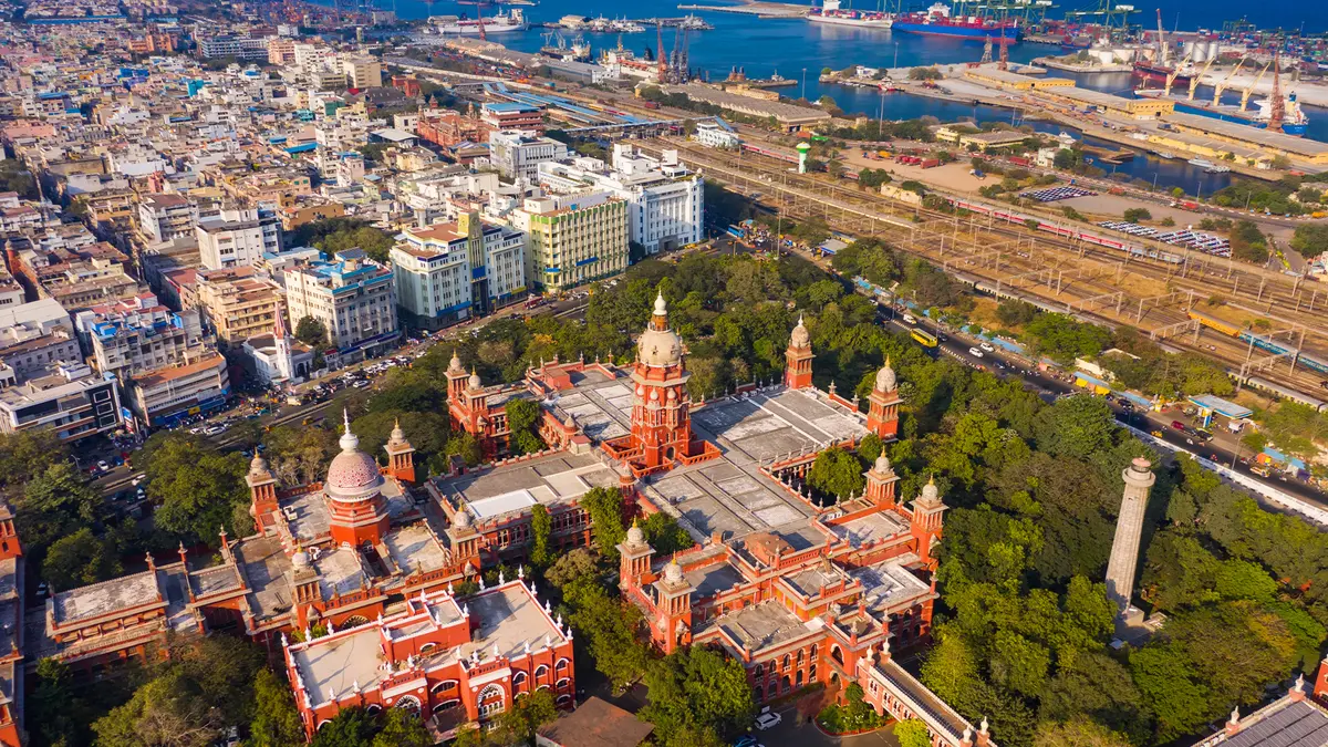 Aerial view of a historic civic landmark surrounded by a bustling heritage city