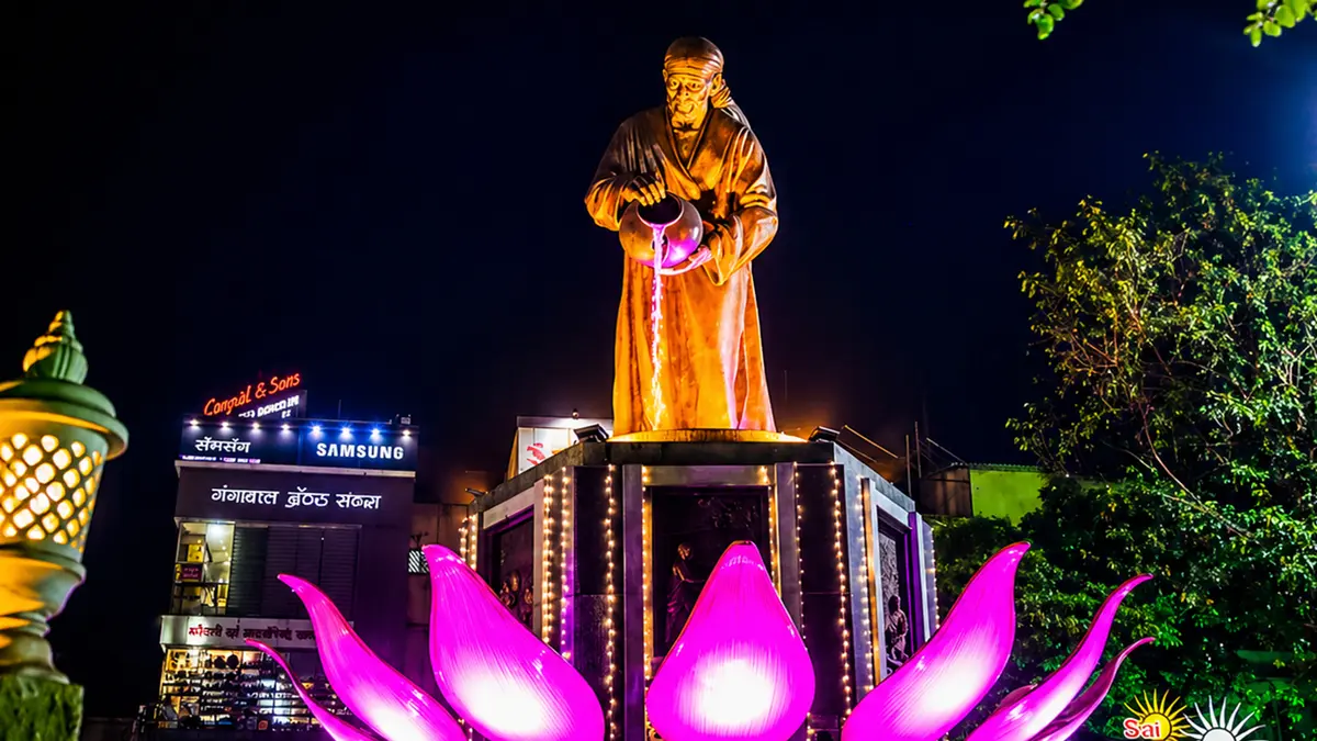Illuminated spiritual landmark plaza featuring a revered statue glowing at night