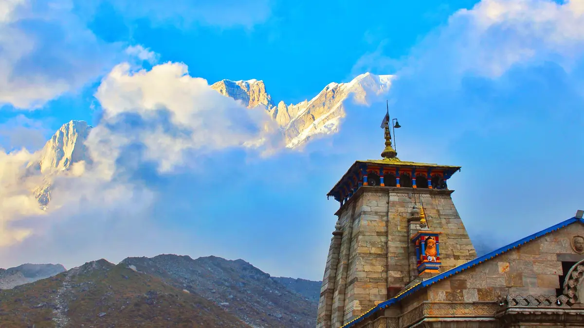 Kedarnath Temple with snow-covered Himalayan peaks glowing during sunrise