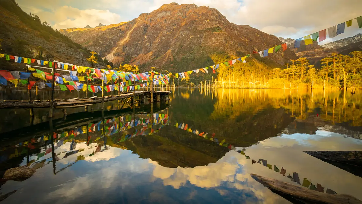 Khecheopalri Lake with colorful prayer flags in West Sikkim