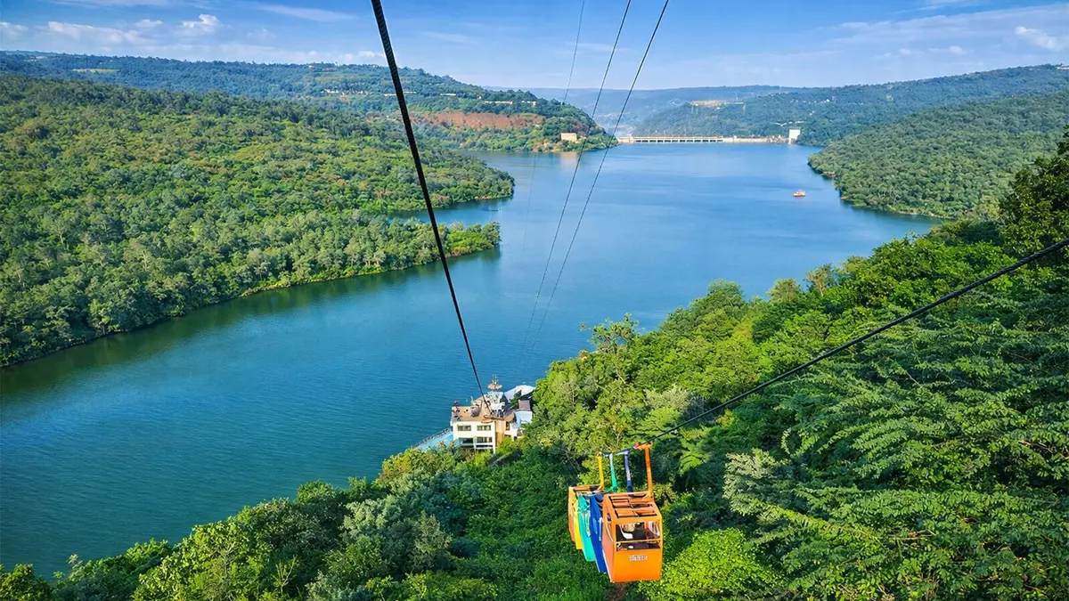 Scenic ropeway crossing the Krishna gorge amid dense forested hills
