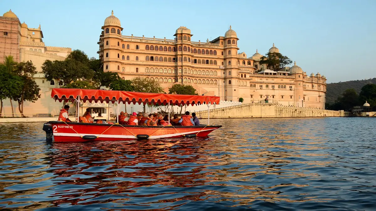 Tourist boat ride on Lake Pichola with Udaipur City Palace in the background
