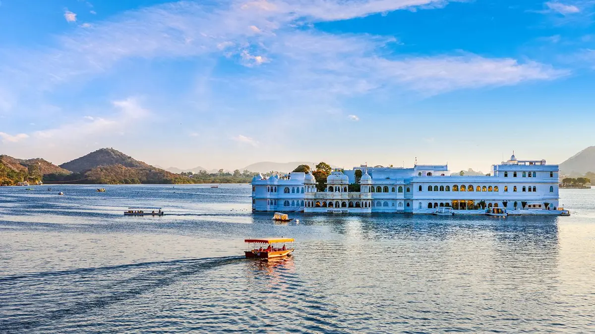 Boat cruising across Lake Pichola with the City Palace in Udaipur