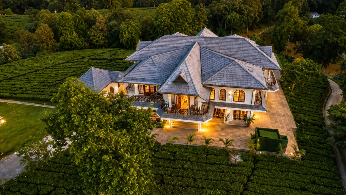 Luxury tea estate resort surrounded by lush tea gardens in Assam