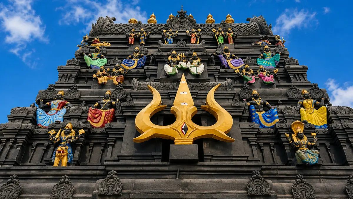 Black stone Mahakaleshwar temple facade with trishul motif and colorful deity sculptures