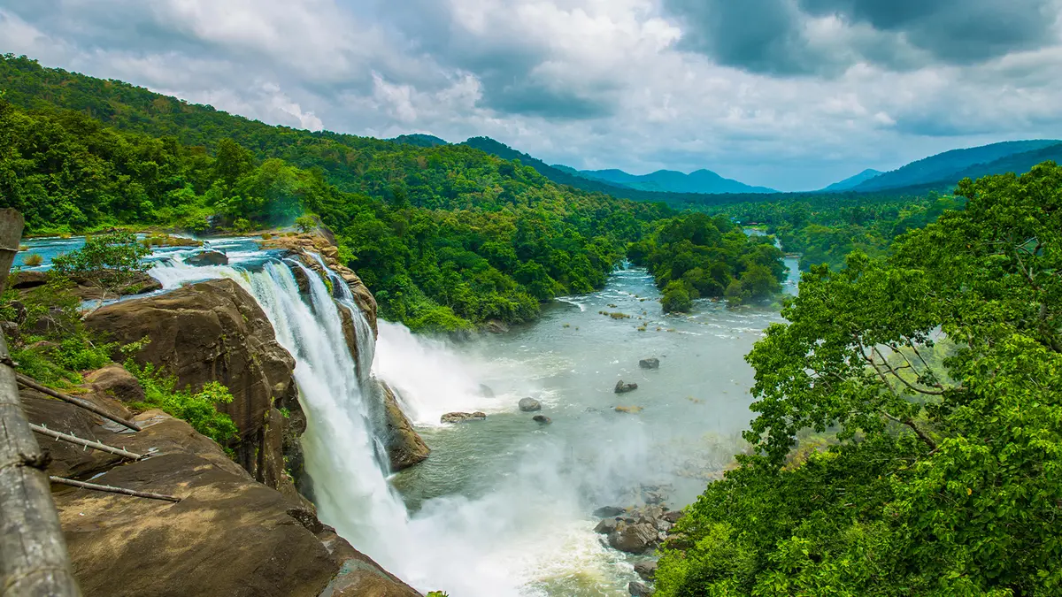 Majestic rainforest waterfall cascading through lush green hills