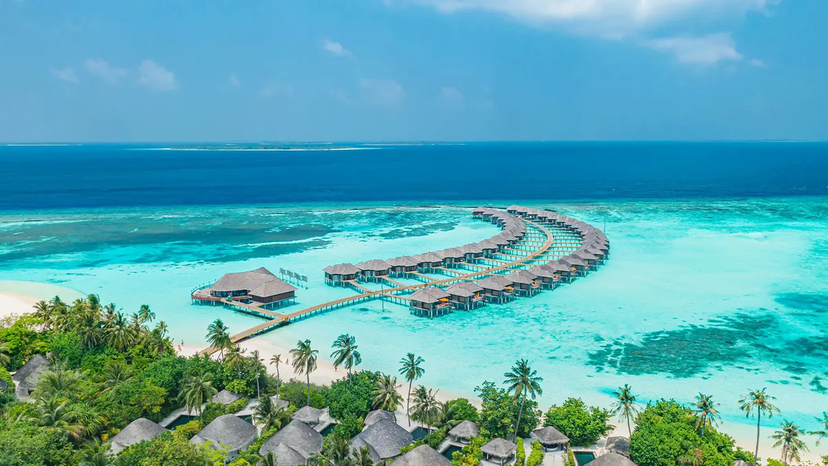 Scenic overwater villa resort surrounded by crystal clear Maldives lagoon