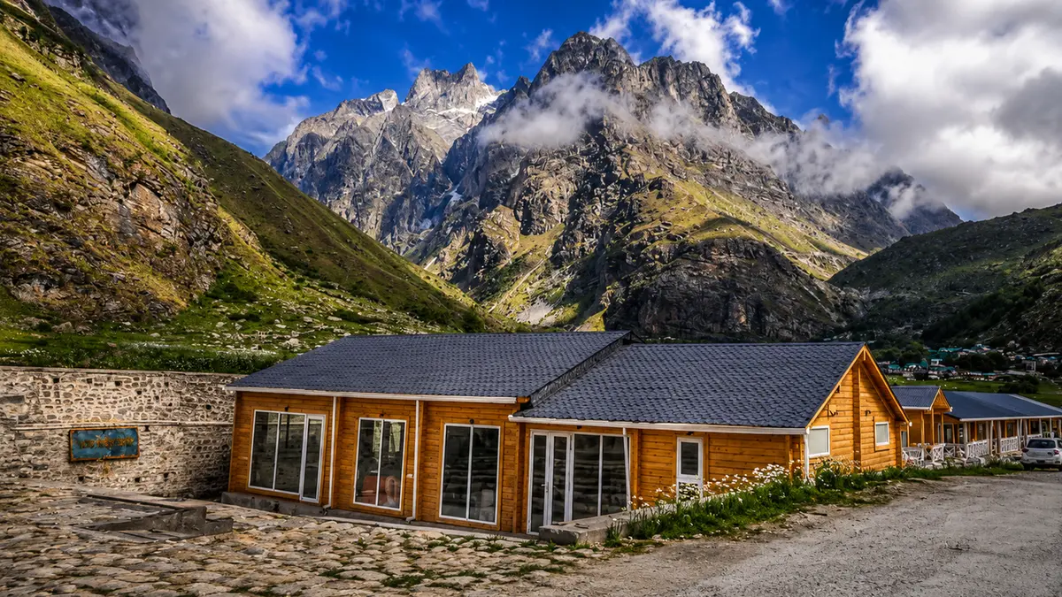 Scenic wooden cottages surrounded by Himalayan peaks near Mana Village in Uttarakhand