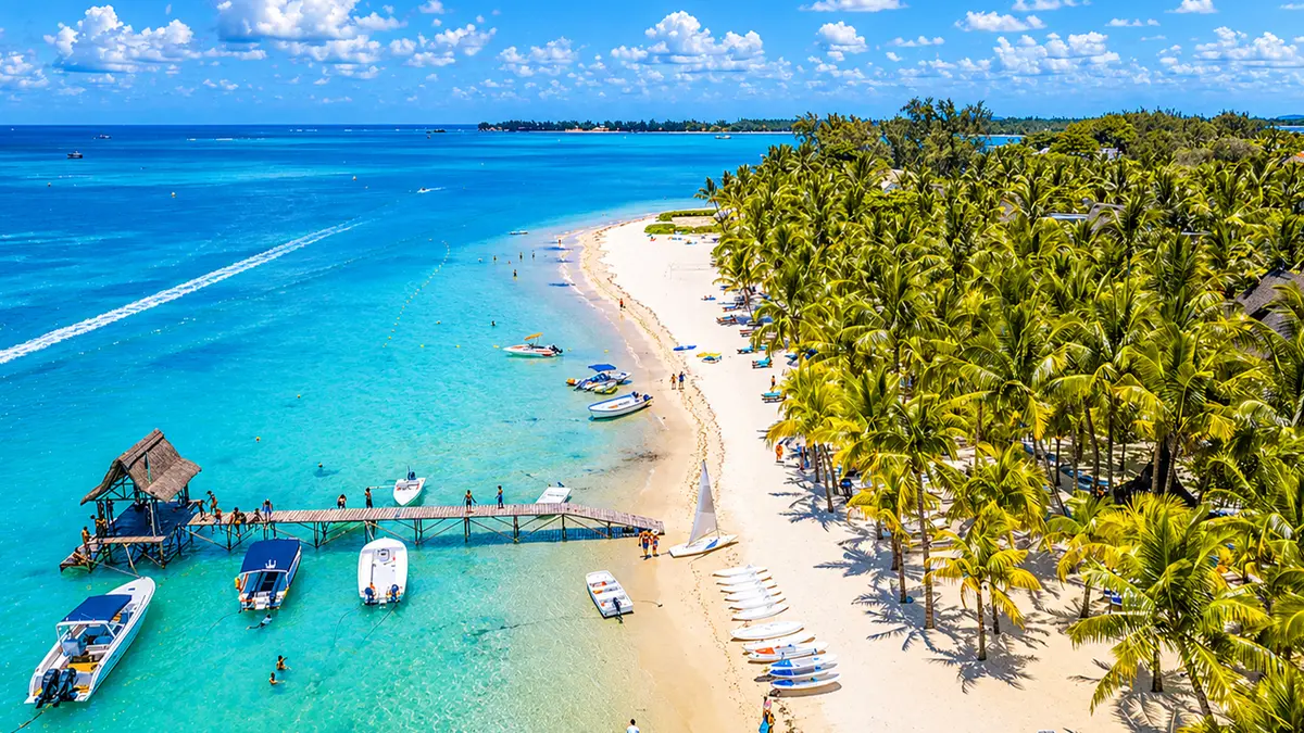 Tropical beach with palm trees and crystal-clear water in Mauritius
