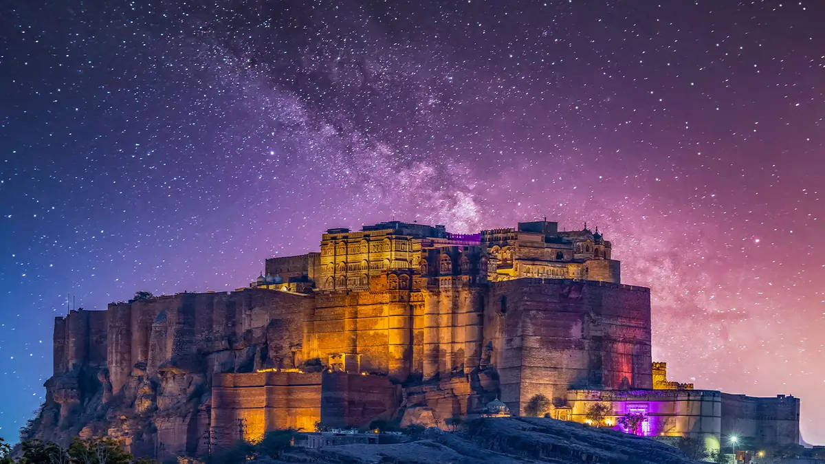 Illuminated Mehrangarh Fort under a star-filled night sky in Jodhpur Rajasthan