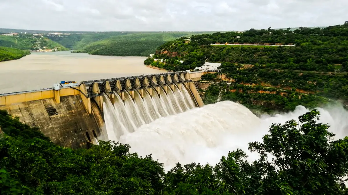 Powerful mountain river dam spillway surrounded by rugged green landscapes