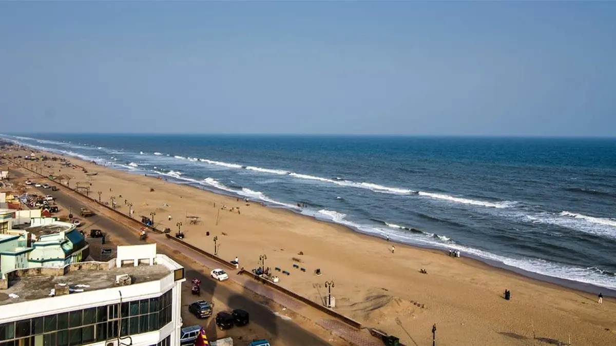 Scenic oceanfront promenade overlooking a wide sandy coastline and blue waters