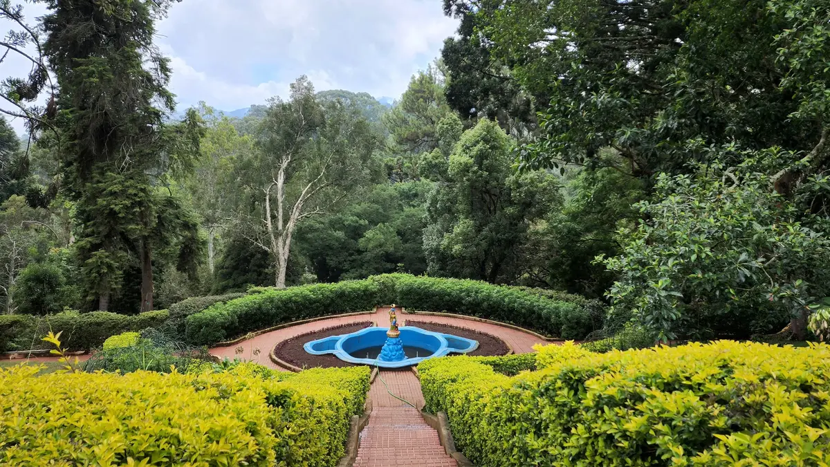 Beautiful landscaped garden at Ooty Botanical Gardens surrounded by Nilgiri greenery